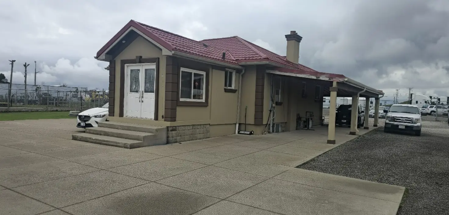 Company facility building with covered parking for fleet vehicles